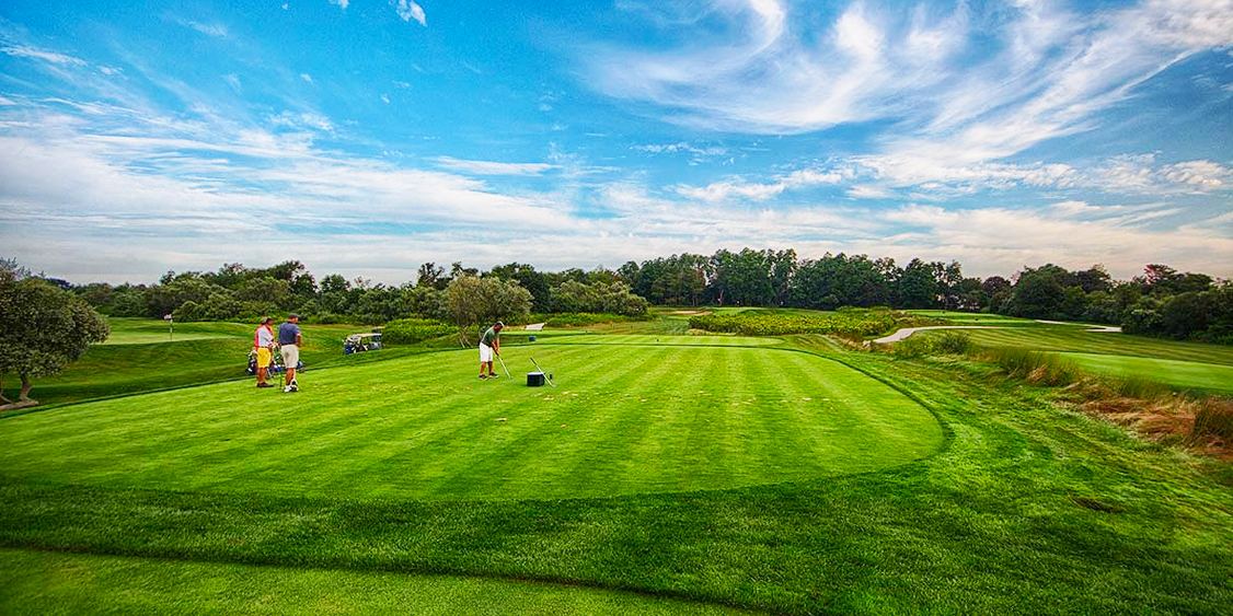 People taking golf lessons and getting ready to swing at Newport National Golf Club in Middletown, RI